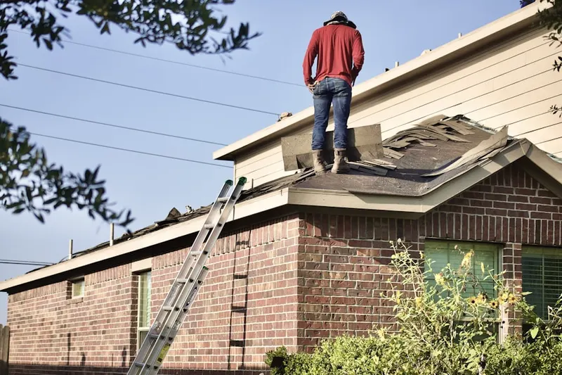 Professional roofer working on a residential roof in Mercedes